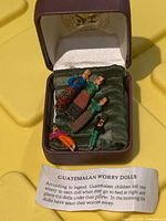Box open showing five worry dolls inside