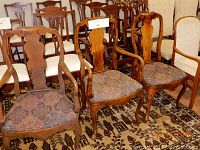 Photo showing three antique wooden armchairs with carved backs and upholstered seats arranged together, highlighting wood condition and upholstery.