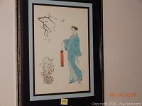 View of framed original artwork showing a woman in traditional East Asian style dress holding a lantern, with floral and bird elements.