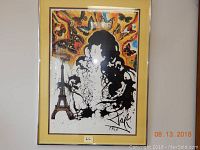 Photo of a framed Salvador Dali 1969 poster with vibrant colors and surreal motifs under glass