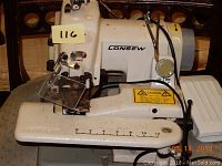 Close-up view of the Consew blind stitch sewing machine showing the needle area and adjustment controls.