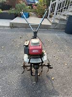 Front view showing overall tiller, handle, tines and engine cover