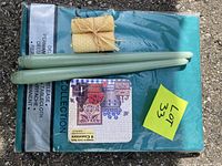 All items grouped: packaged teal tablecloth, coaster set, green taper candles, beeswax bundle