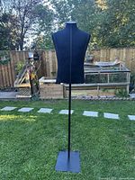 Full view of black male dress form on pole and square base
