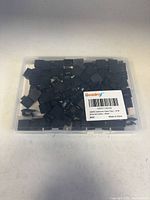 Closed clear box filled with black cable clips, Boazimy barcode label visible