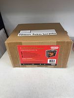 Closed brown shipping box showing product label for Evoretro acrylic protector