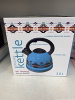 Front of boxed Nu Trendz kettle showing product image and key features