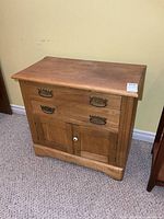 front view showing drawers, doors, brass pulls