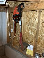 Overall view of both power tools hanging on wall studs