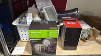 Overall lot with Mr Beams spotlight, Duracell flashlight, outlet box, 12 V motor and basket of parts