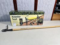 Boxed Rumford Gardener kneeler seat alongside long-handled weeder