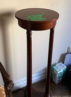 Full view of pedestal stand beside wall