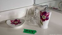 Group shot of ceramic dispenser, dish, and glass swan