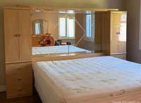 Full view of headboard, mirror, and attached cabinets