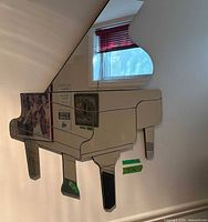Front view of piano-shaped mirror mounted on wall