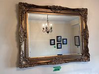 Full view of gilded baroque wall mirror mounted on wall
