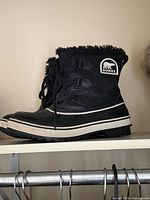 Left side view of both boots displaying Sorel logo, lace system, material contrast