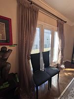 Full view of both curtain panels hung on rod in window opening