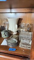 Full group on shelf: pitcher, coasters, tray, trinket box, dishes, vases, cherub holder