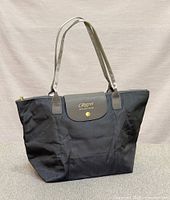 Front view of tote bag with Regent branding, showing handles, flap, and snap