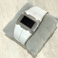 Front view of Kenneth Cole digital watch on cushion