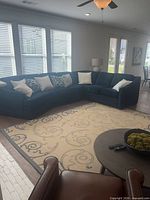 Blue microfiber sectional sofa with beige rug in living room