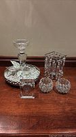 Group view of crystal clock, candlestick, tray with filler, two sphere votive holders, rectangular candle holder