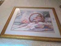 Full view of the framed lithograph showing the coastal shell basket scene with gold-tone frame.