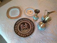 Overview of the lot showing three decorative plates and three Delft hand-painted ceramic vases on a white quilted surface.