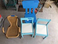 Top-down view of all four children's chairs arranged in a cluster, showing different styles and materials.