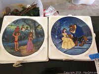 Photo of two Disney Beauty and the Beast plates each 8.5 inches, one showing a jungle scene, the other Belle dancing with Beast under starry sky.