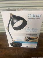 Front of box showing OttLite Wellness Series LED desk lamp image and branding