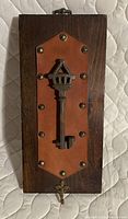 front view showing key, leather patch, brass hook