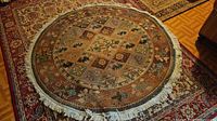 Full view of circular rug showing pattern and fringe