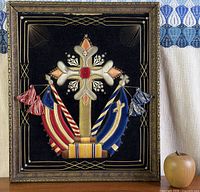 Full view of framed embroidered textile on display
