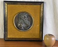 Front view showing framed bronze relief plaque and overall presentation