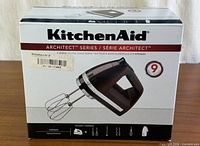 Front of box showing KitchenAid Architect Series 9-speed hand mixer image and branding