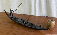 Full side view of bronze gondola with apple for scale