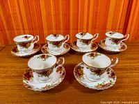 Six Royal Albert Old Country Roses teacups with matching saucers displayed on table