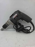 Right-side view of Black & Decker drywall screwgun with cord coiled