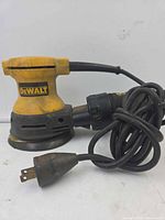 Left side view showing DeWALT logo, pad, cord and plug