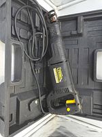 Saw in open carrying case showing cord and plug