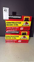 Front view of two sealed Rhynopac contractor bag boxes showing branding, capacity and quantity