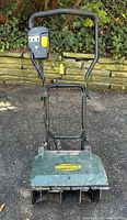 Full front view of Yardworks electric snow shovel showing handle, housing and wheels