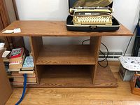 Front view of wooden shelve unit showing two internal shelves and flat top surface with visible wood grain.