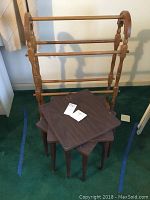 Wooden folding drying rack displayed with three small square tables in front, showing overall shape and scale.