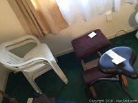 Two white plastic chairs and two stools, one footrest upholstered and one metal with bicycle seat, arranged on carpet