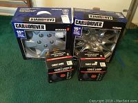 Photo of 2 Car and Driver branded 15 inch wheel covers (Modena and Torino models) and 2 boxed Allison Curly Lamb Universal Bucket seat covers.