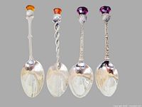 Front view of all four thistle spoons