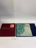 Two outer slipcases (maroon and teal) of the Beethoven Bicentennial Collection